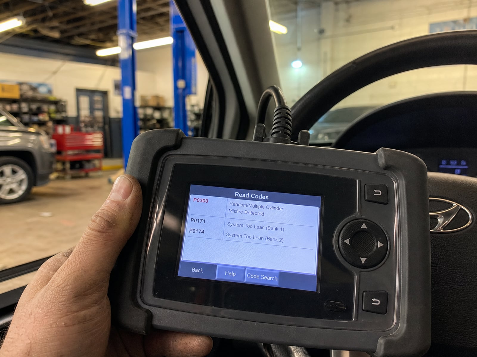 Handheld scan tool reading engine fault codes during diagnostics
