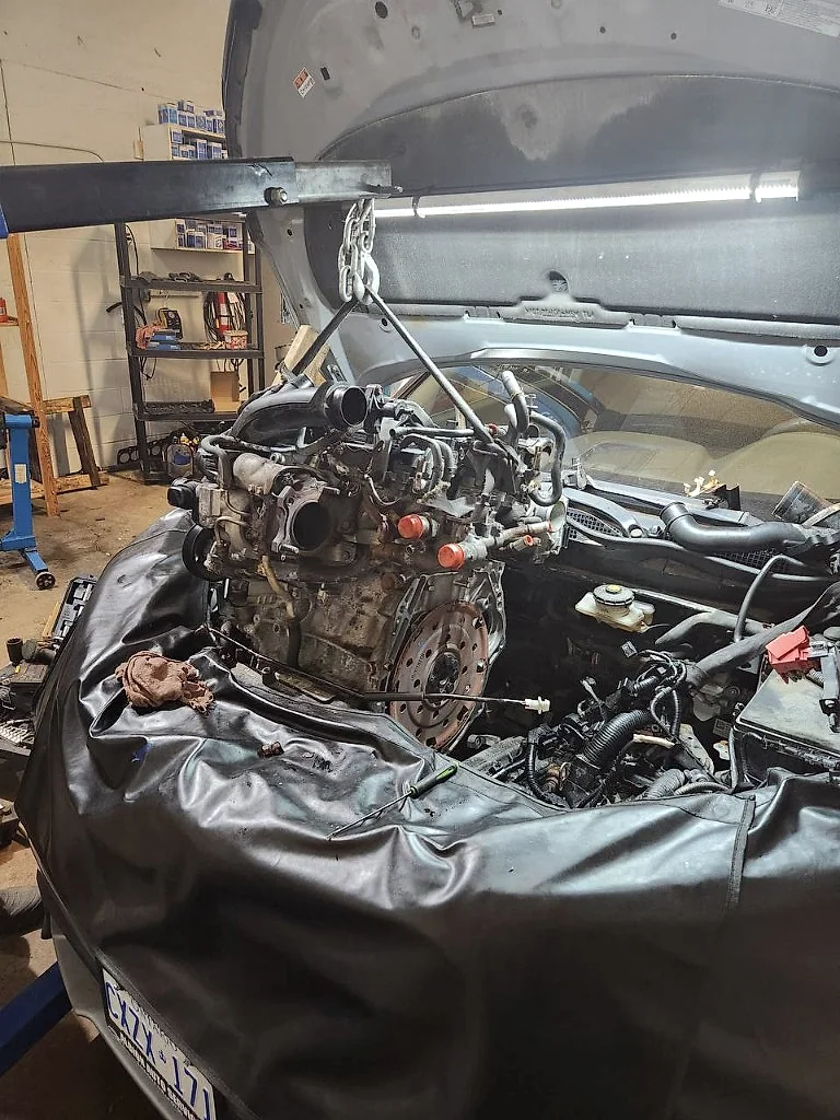 Engine being lifted from a vehicle in the MotorDoc bay